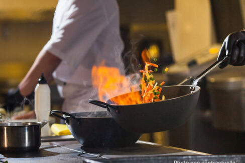 cook making dinner in the kitchen of high-end restaurant.